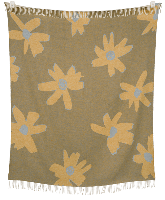 Floral patterned throw blanket with yellow flowers on a brown background