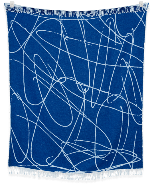 Blue blanket with white abstract patterns on a black background