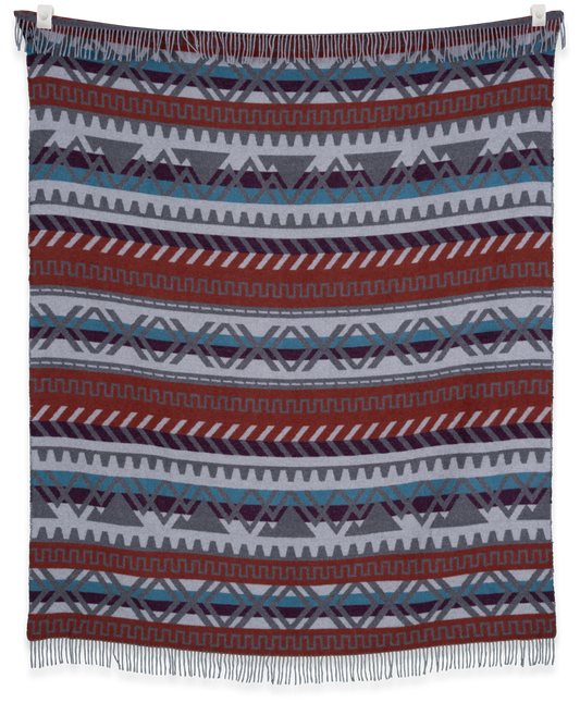 Woven blanket with geometric pattern on a white background