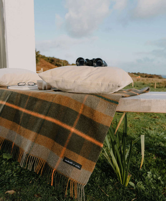 Plaid blanket on a table outdoors with scenic background