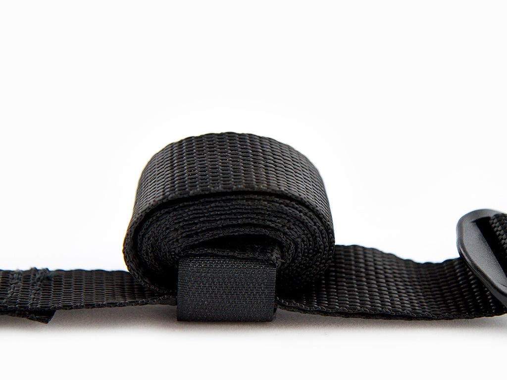 Black webbing strap with a buckle on a white background
