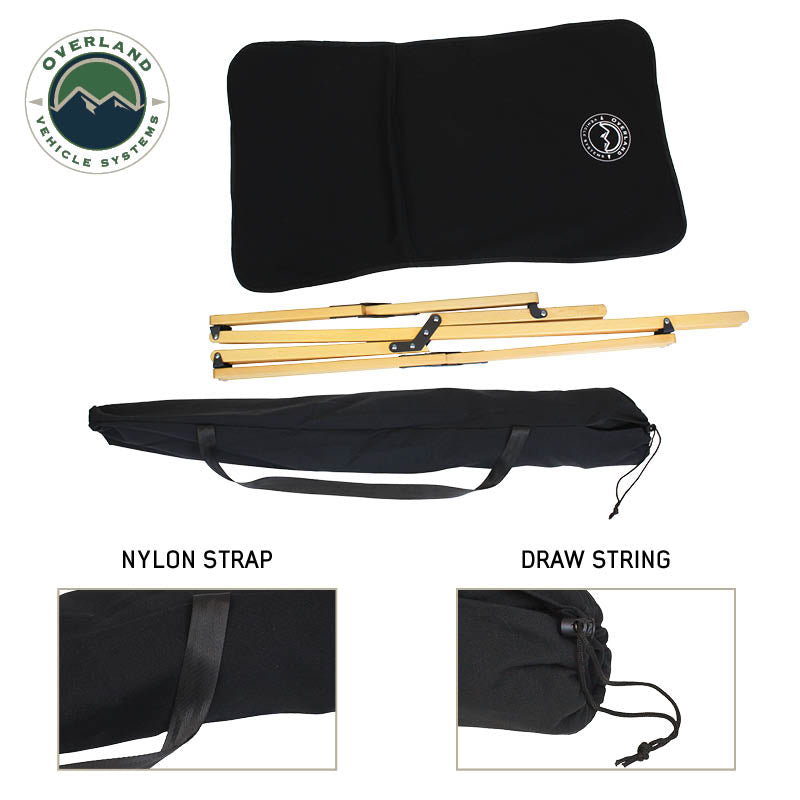 Black camping chair folded with storage  bag with  Overland Vehicle Systems logo on a white background