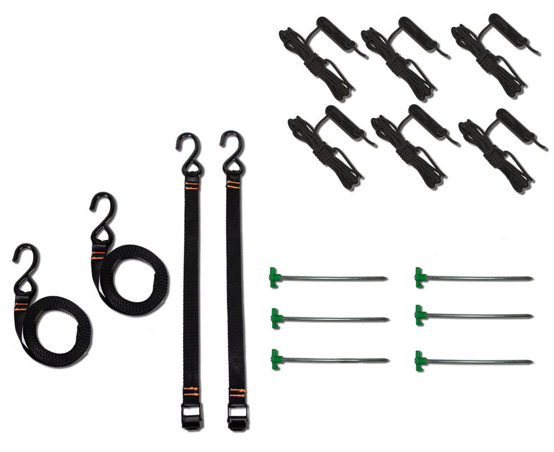 Collection of awning accessories including straps, hooks, and stakes on a white background