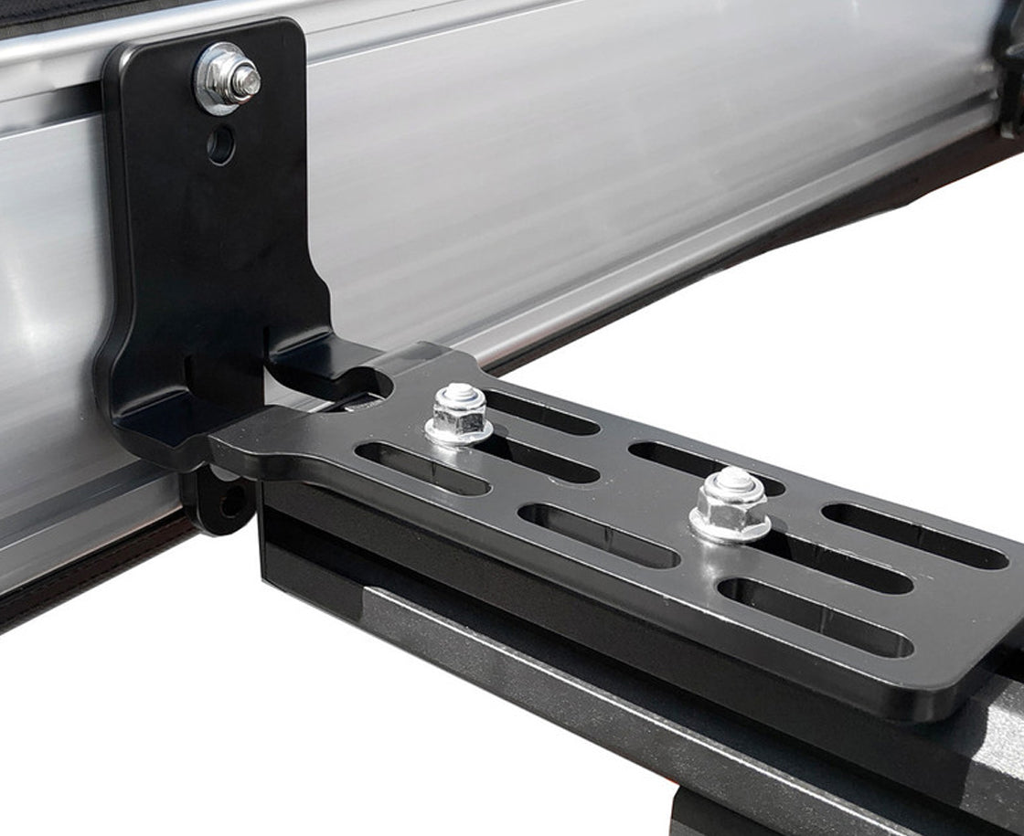 Black metal awning mount on a vehicle with bolts