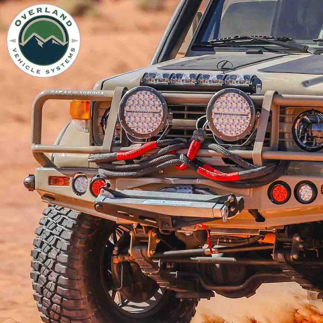 Off-road vehicle with additional lights and Overland Vehicle Systems logo.