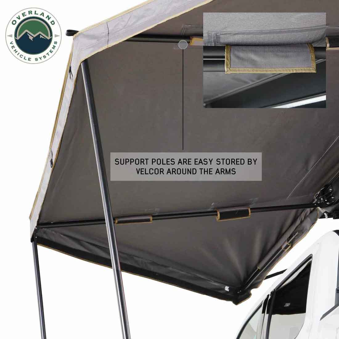Awning with support poles stored using Velcro around the arms, branded 'Overland Vehicle Systems'.