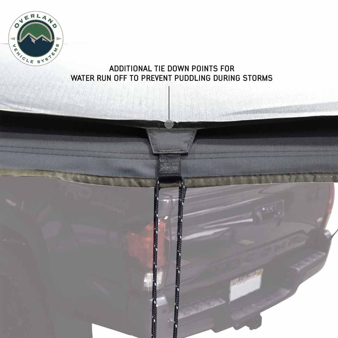 Awning with tie-down points on a vehicle, featuring Overland Vehicle Systems logo.