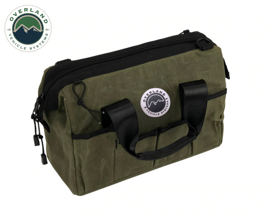 Green bag with black handles and zippers on a white background, featuring Overland Vehicle Systems logo.