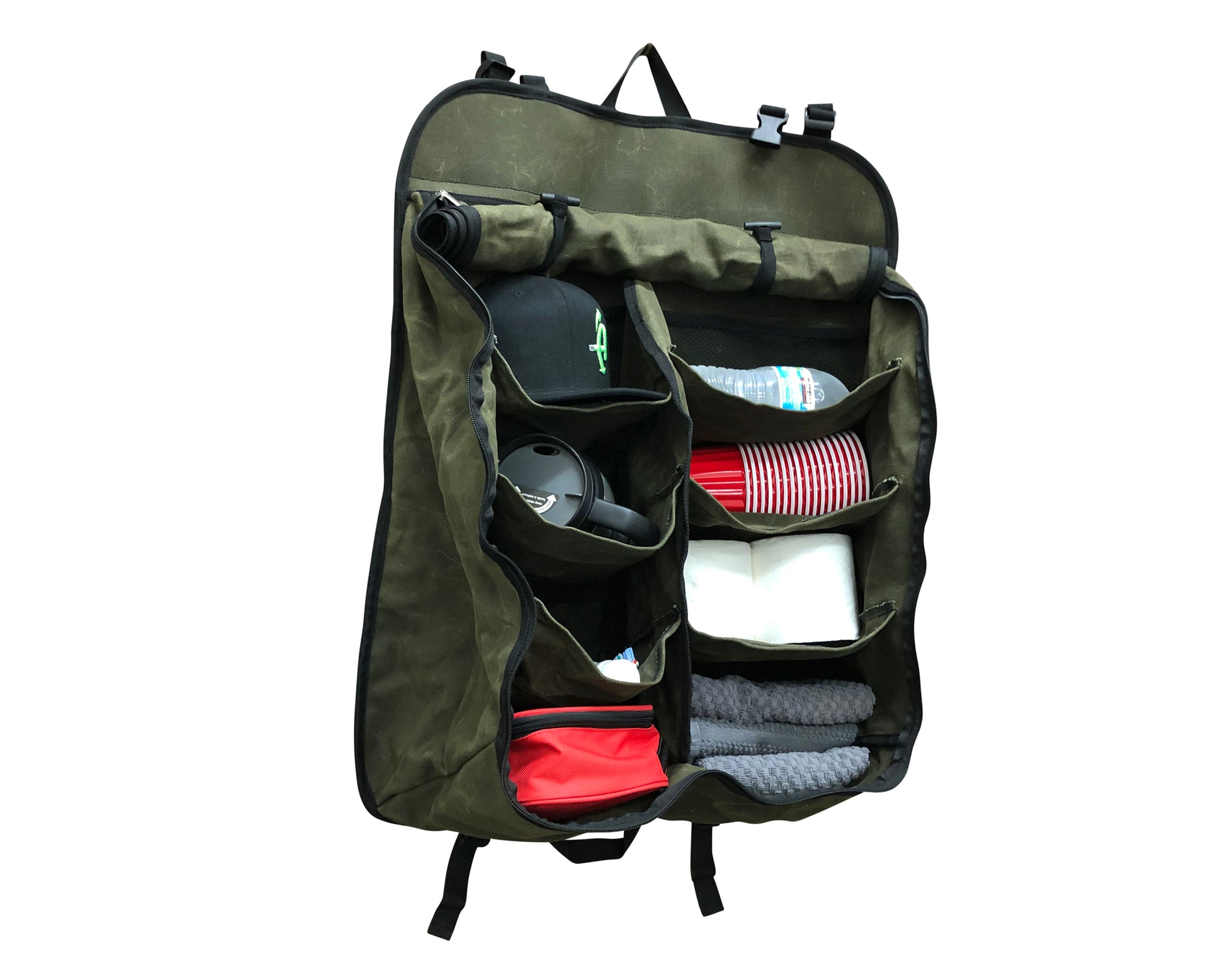 Green travel organizer bag with various items inside on a white background