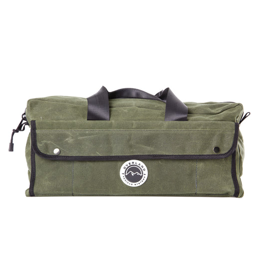 Green duffel bag with black handles and trim on a white background