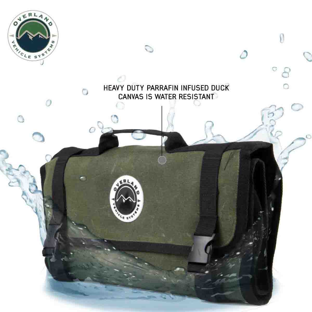 Green roll-up bag with black straps on a white background, featuring the Overland Vehicle Systems logo.