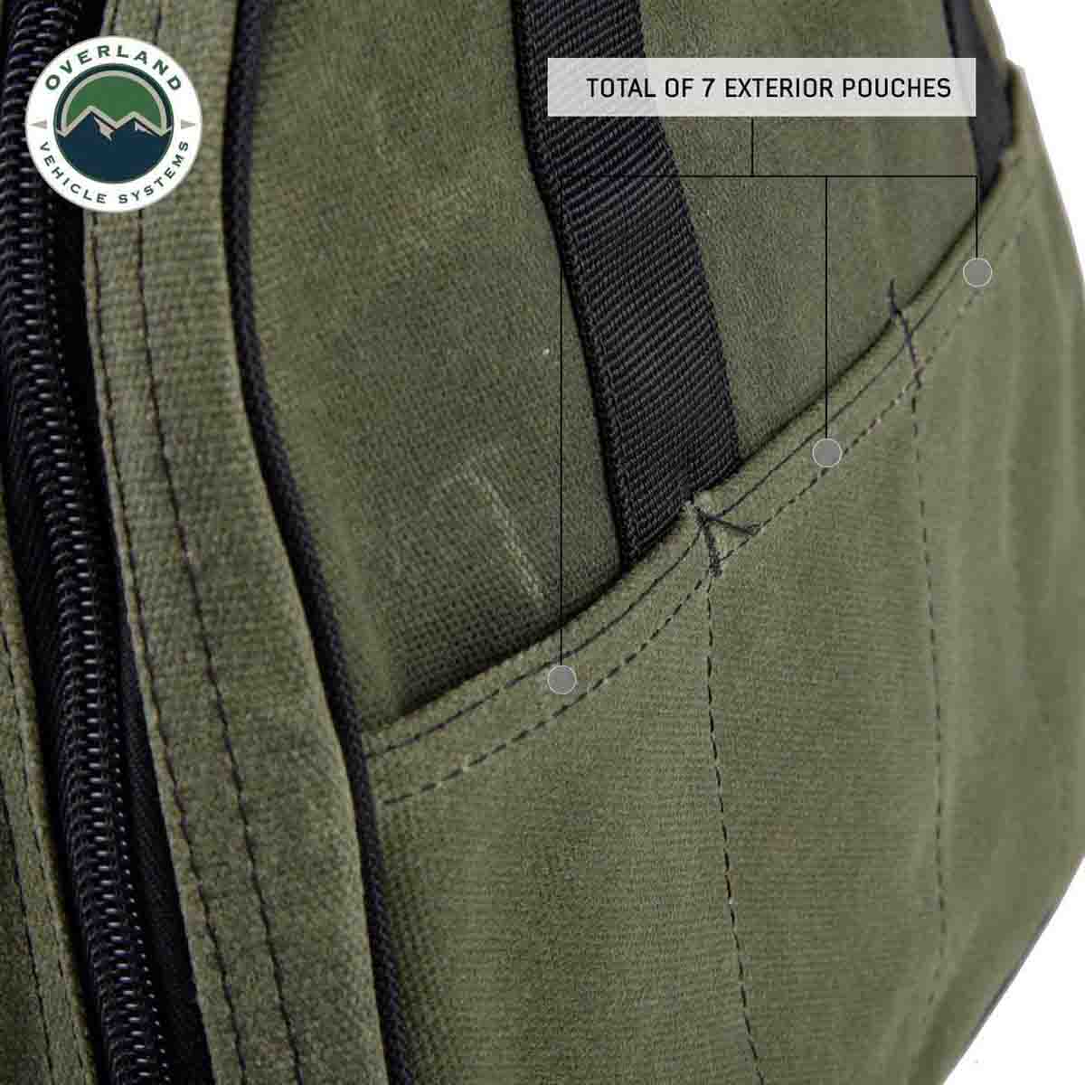 Green jumper cable bag with multiple exterior pouches and Overland Vehicle Systems logo.