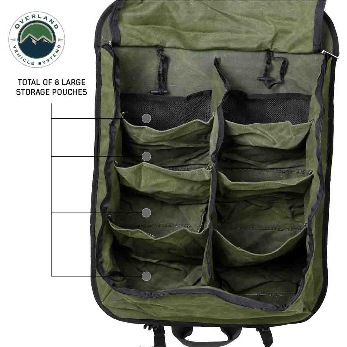 Green storage bag with multiple pockets and Overland Vehicle Systems logo.