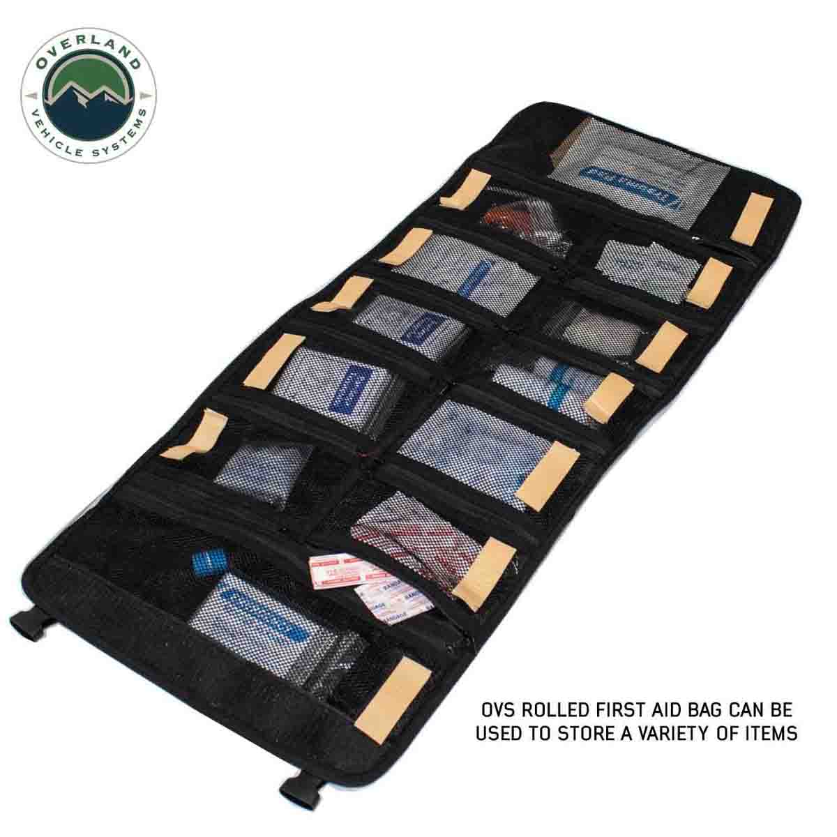 Rolled first aid bag with various compartments on a white background, featuring Overland Vehicle Systems logo.