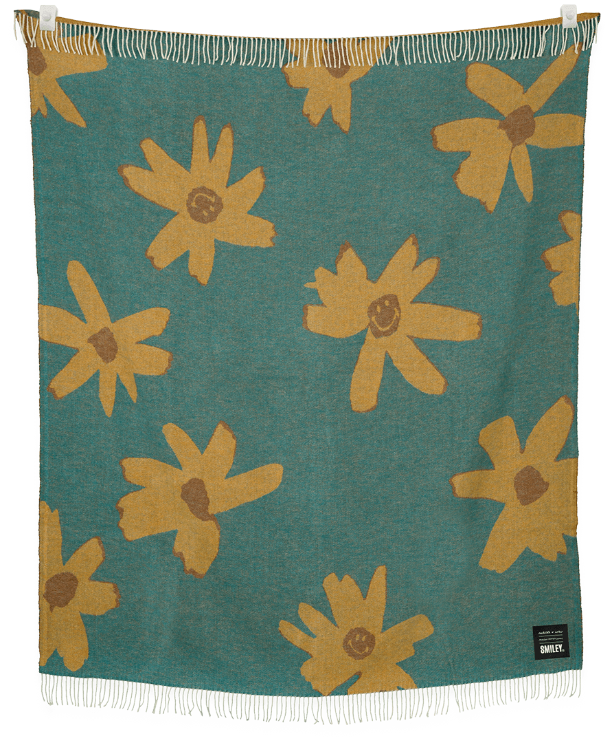 Floral patterned blanket with yellow flowers on a teal background