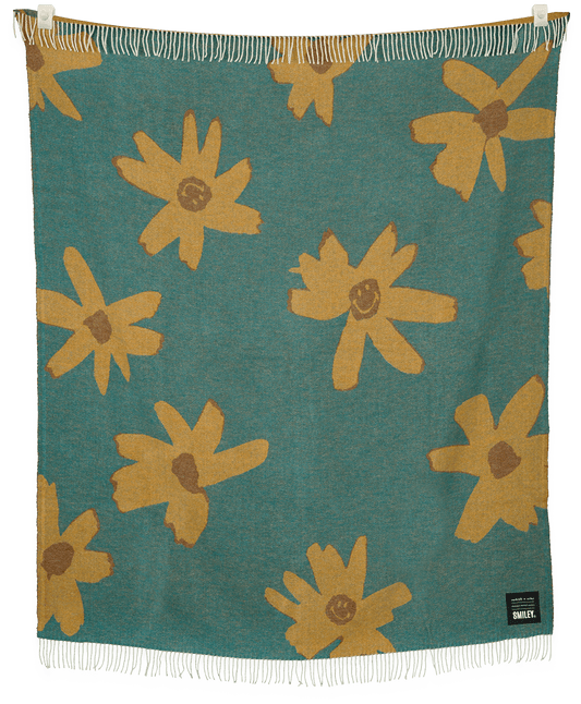 Floral patterned blanket with yellow flowers on a teal background