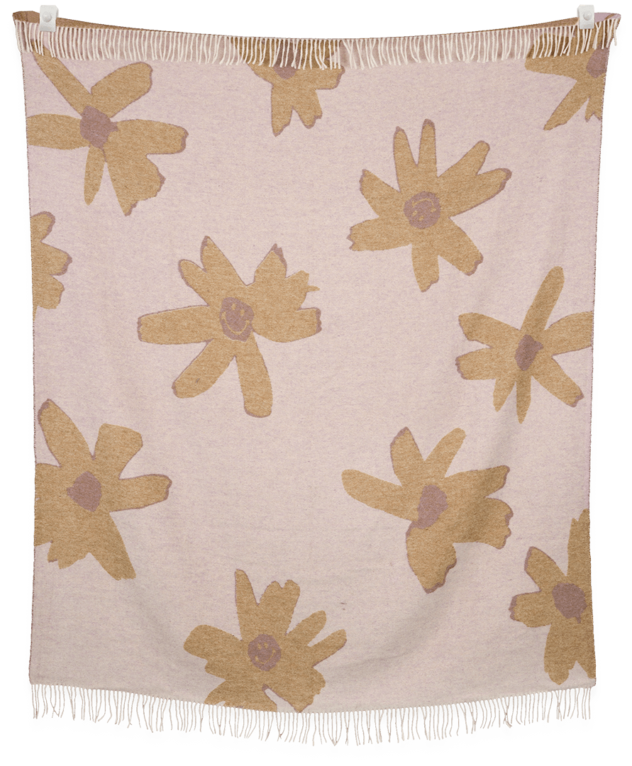 Floral patterned throw blanket with beige flowers on a light pink background