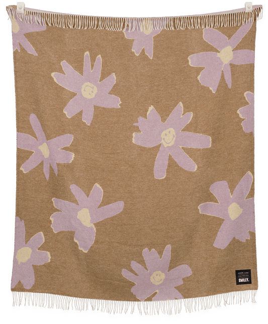 Floral patterned blanket with purple flowers on a brown background, featuring the brand 'Sweetie'.
