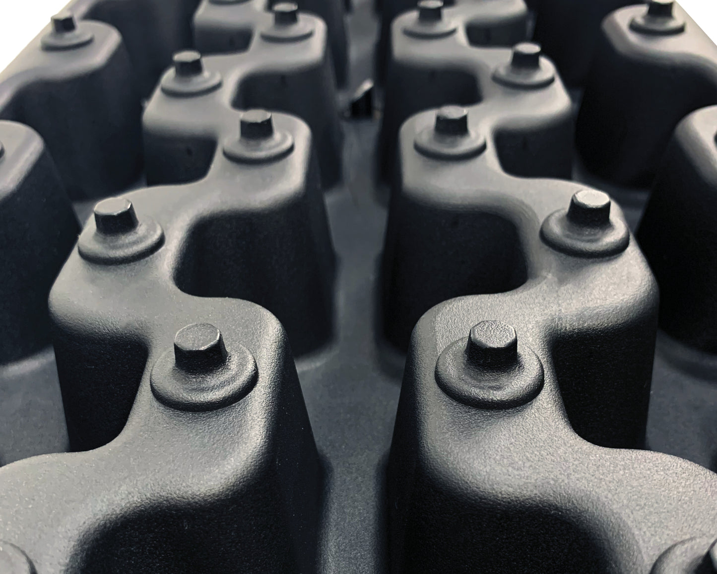 Close-up of a black metal chain with links and bolts.