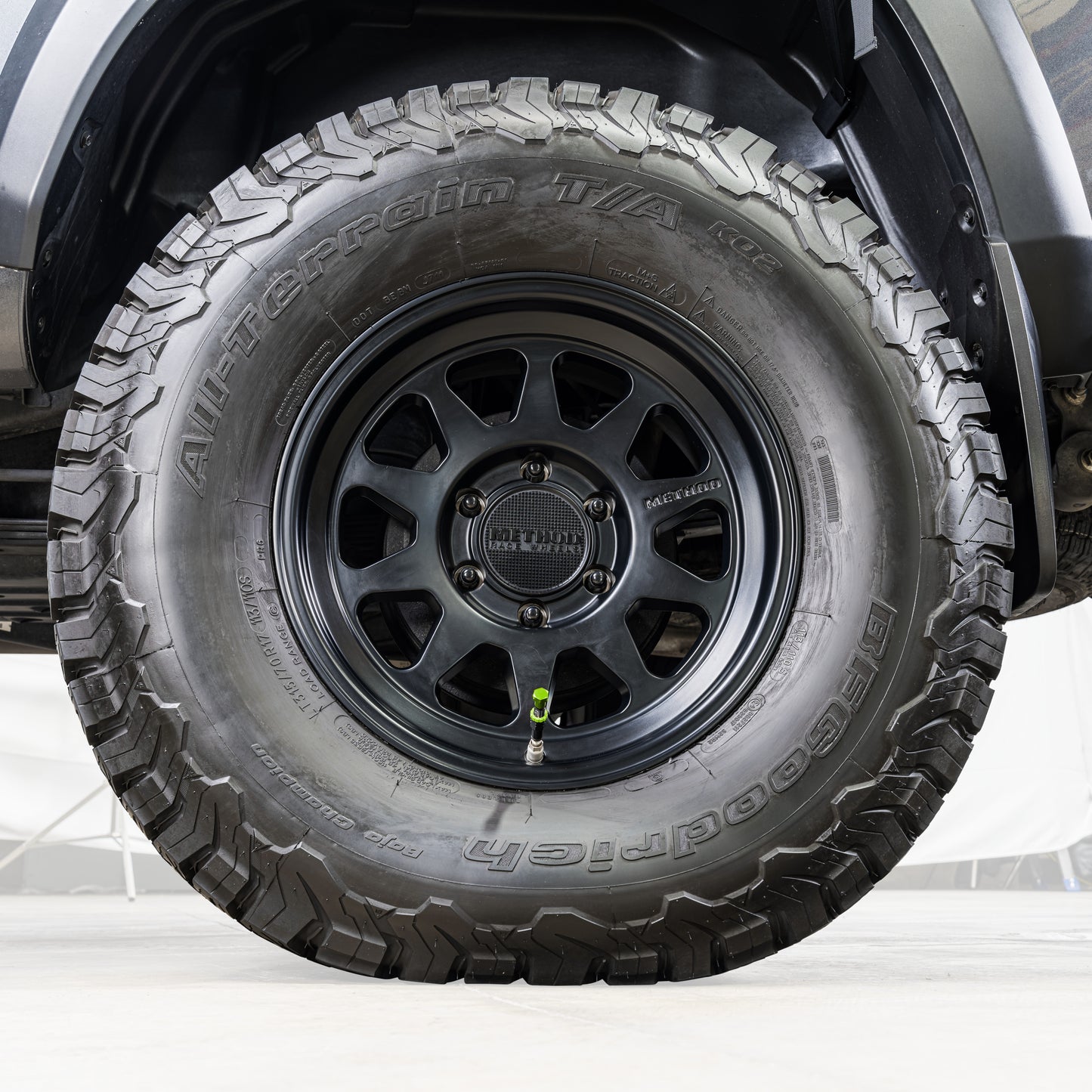Close-up of a tire with a detailed tread pattern on a vehicle.
