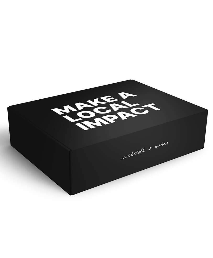 Black box with 'MAKE A LOCAL IMPACT' text on a white background