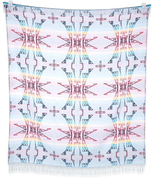 Colorful geometric patterned fabric hanging on a black background