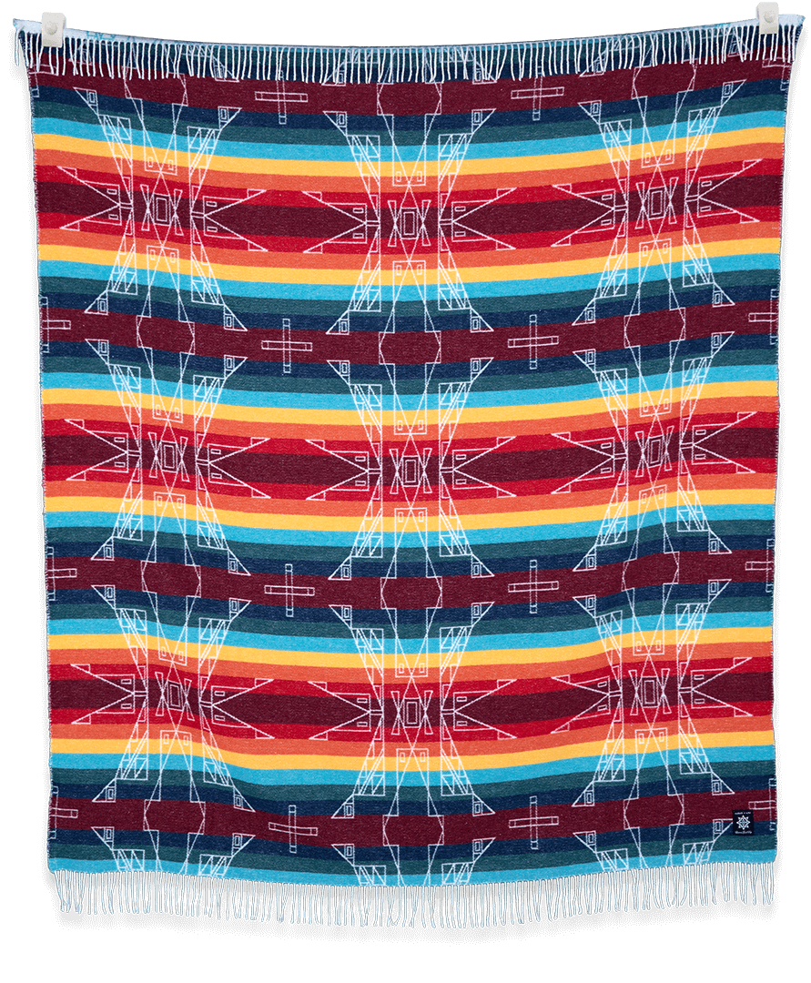 Colorful woven blanket with geometric pattern on a black background