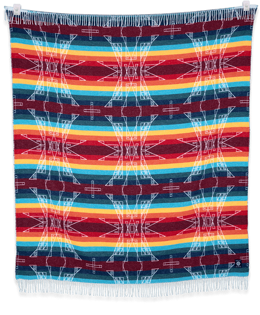 Colorful woven blanket with geometric pattern on a black background