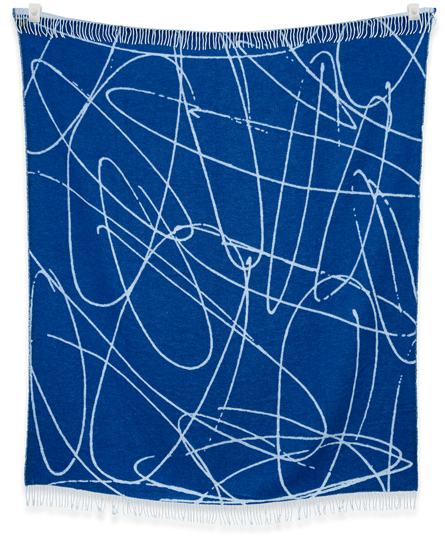 Blue blanket with white abstract patterns on a black background