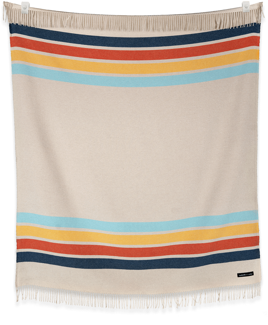 Beige blanket with colorful horizontal stripes on a black background