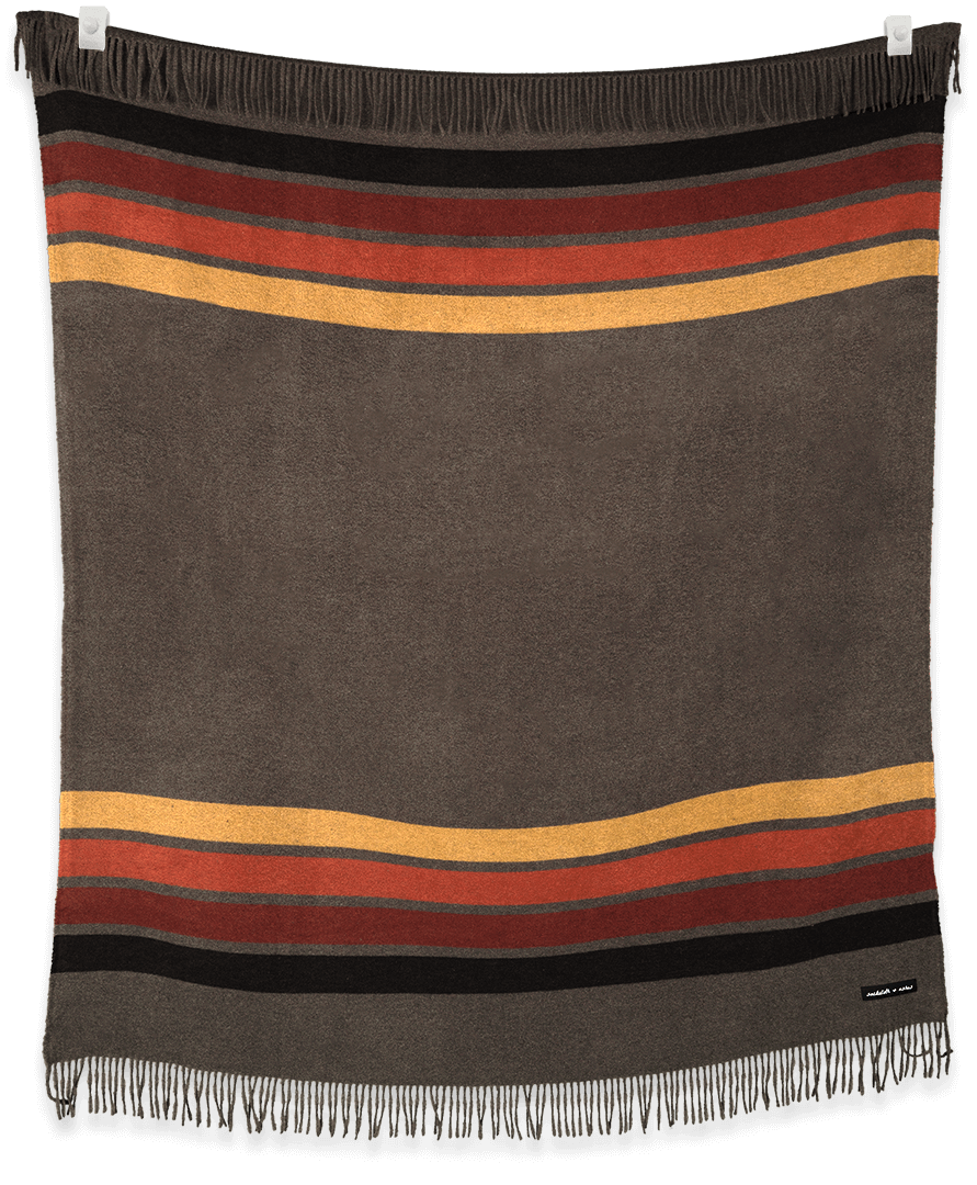 Striped blanket with brown, red, and yellow colors on a black background