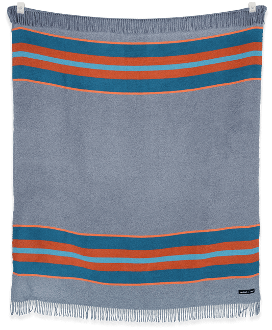 Striped blanket with blue and orange stripes on a black background
