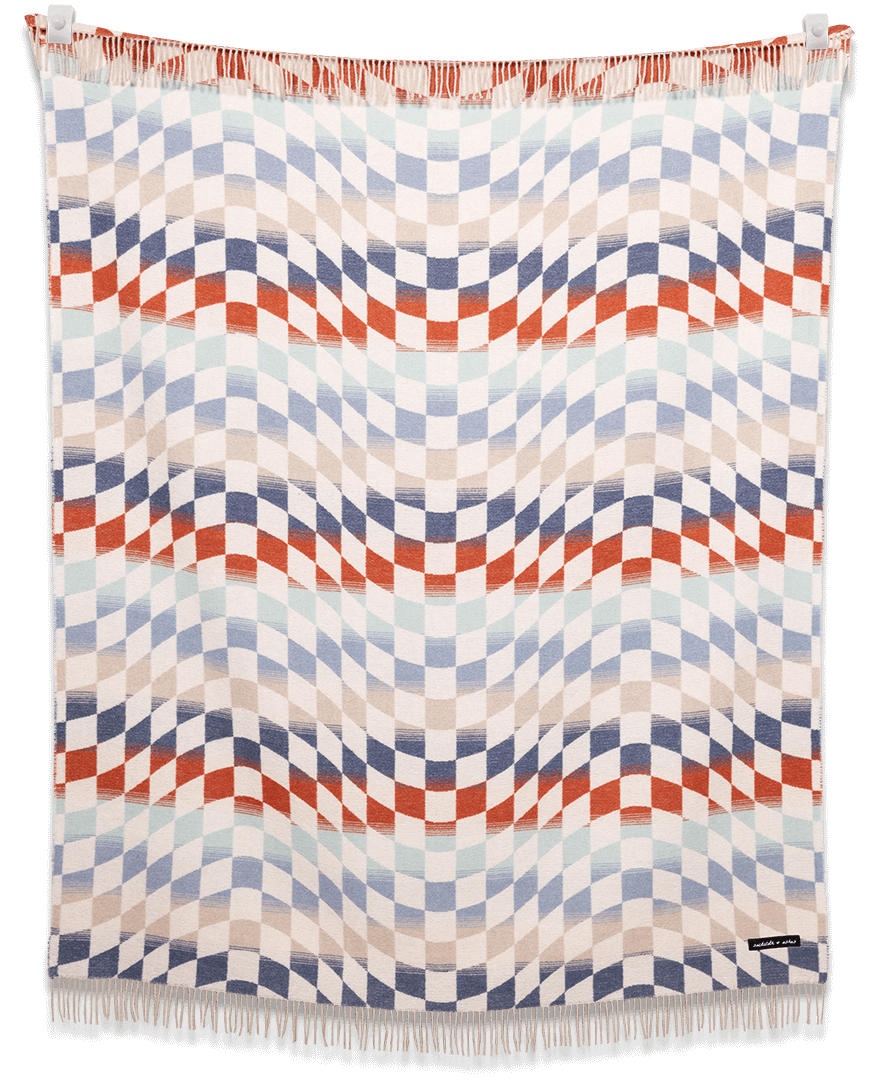 Woven blanket with geometric pattern on a black background