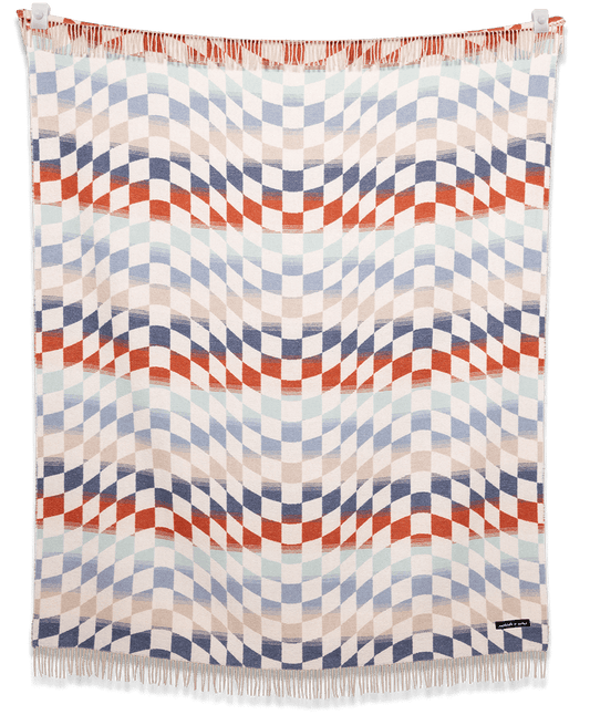 Woven blanket with geometric pattern on a black background