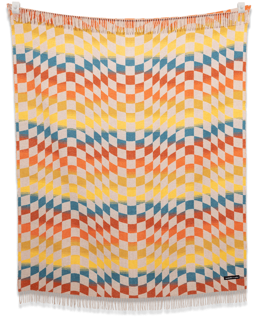 Colorful woven blanket with geometric pattern on a black background