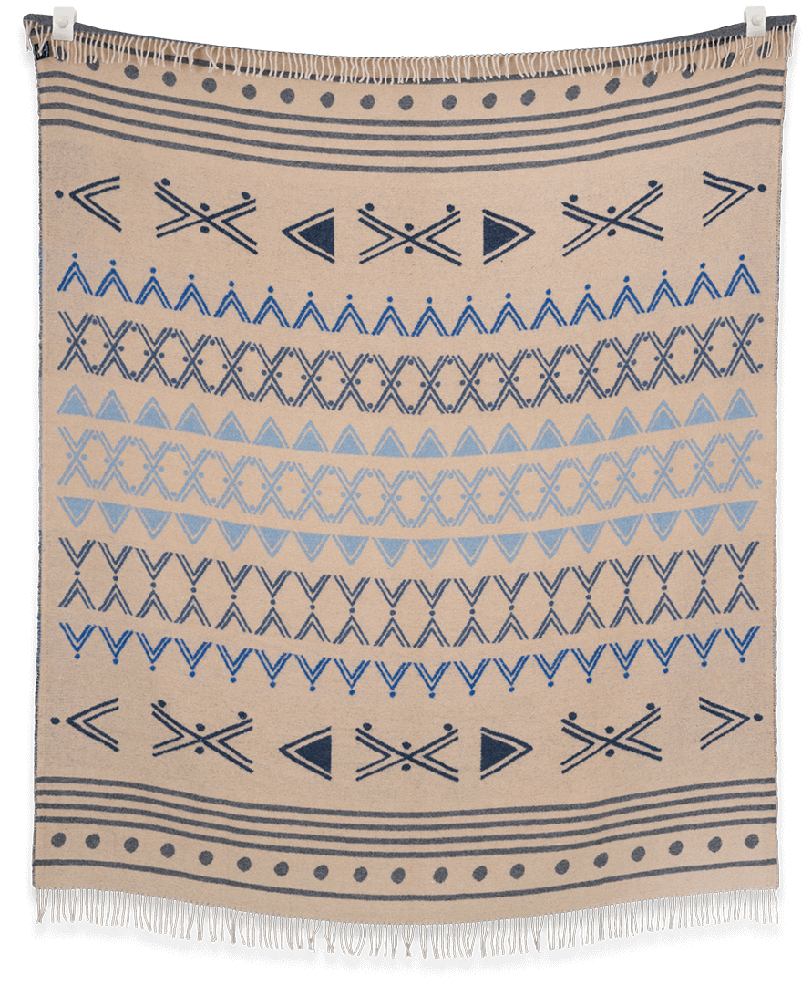 Beige blanket with blue geometric patterns on a black background