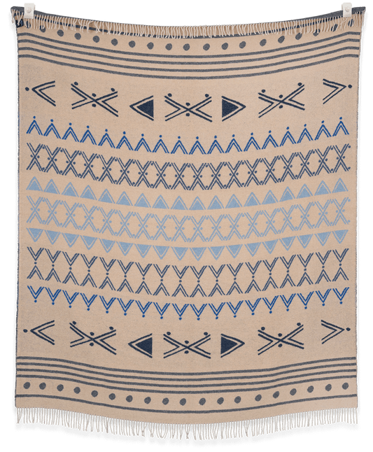 Beige blanket with blue geometric patterns on a black background