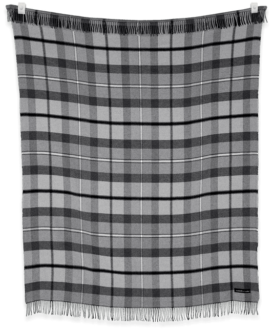 Plaid blanket with black and gray colors on a black background