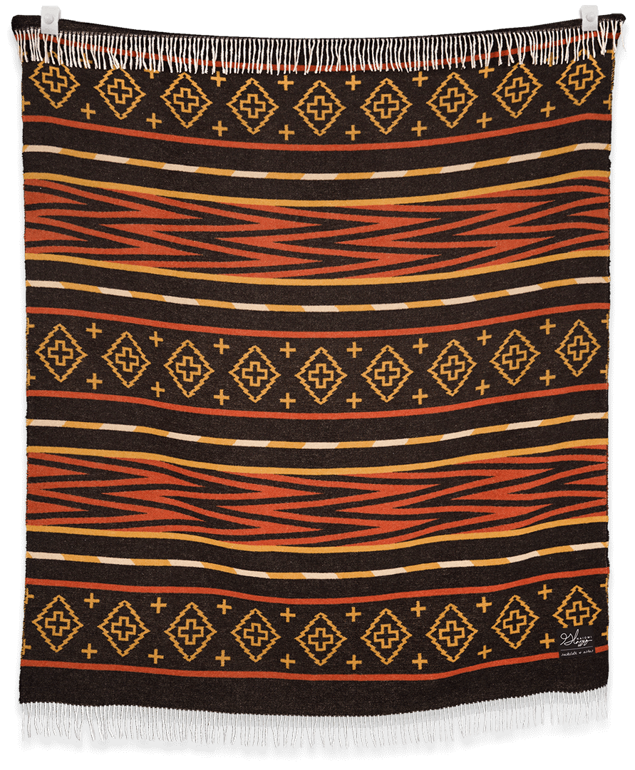 Woven blanket with geometric pattern on a black background