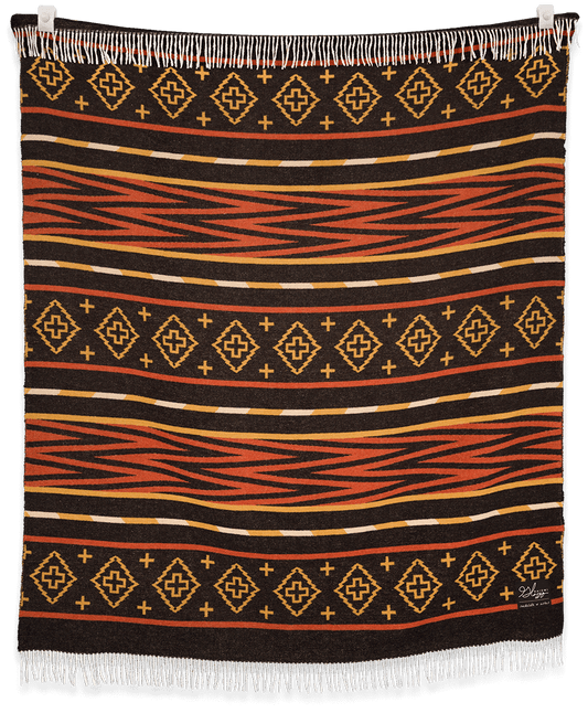 Woven blanket with geometric pattern on a black background