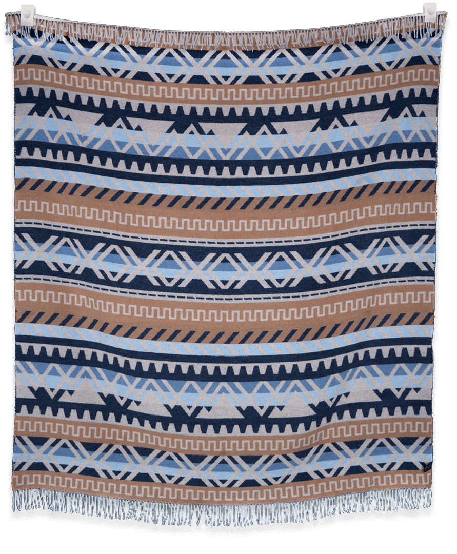 Blanket with geometric pattern in blue, brown, and white on a black background