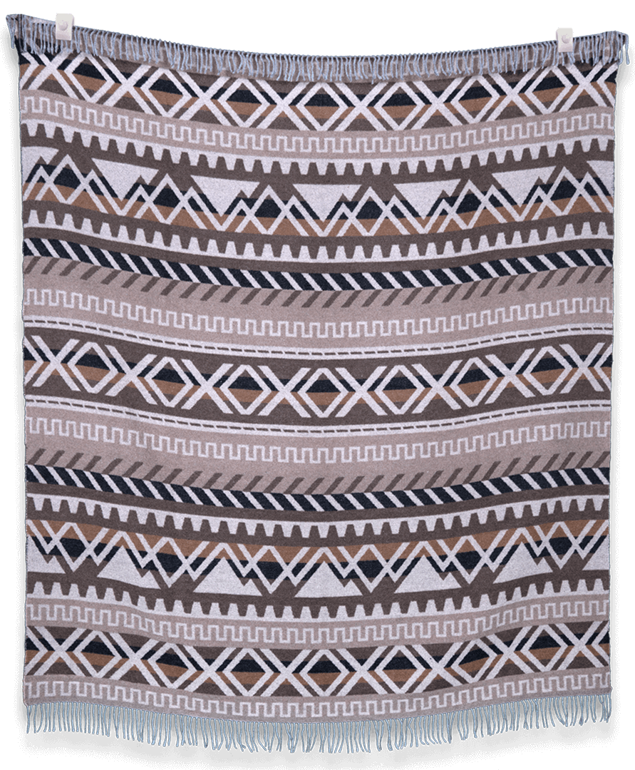 Woven blanket with geometric pattern on a plain background