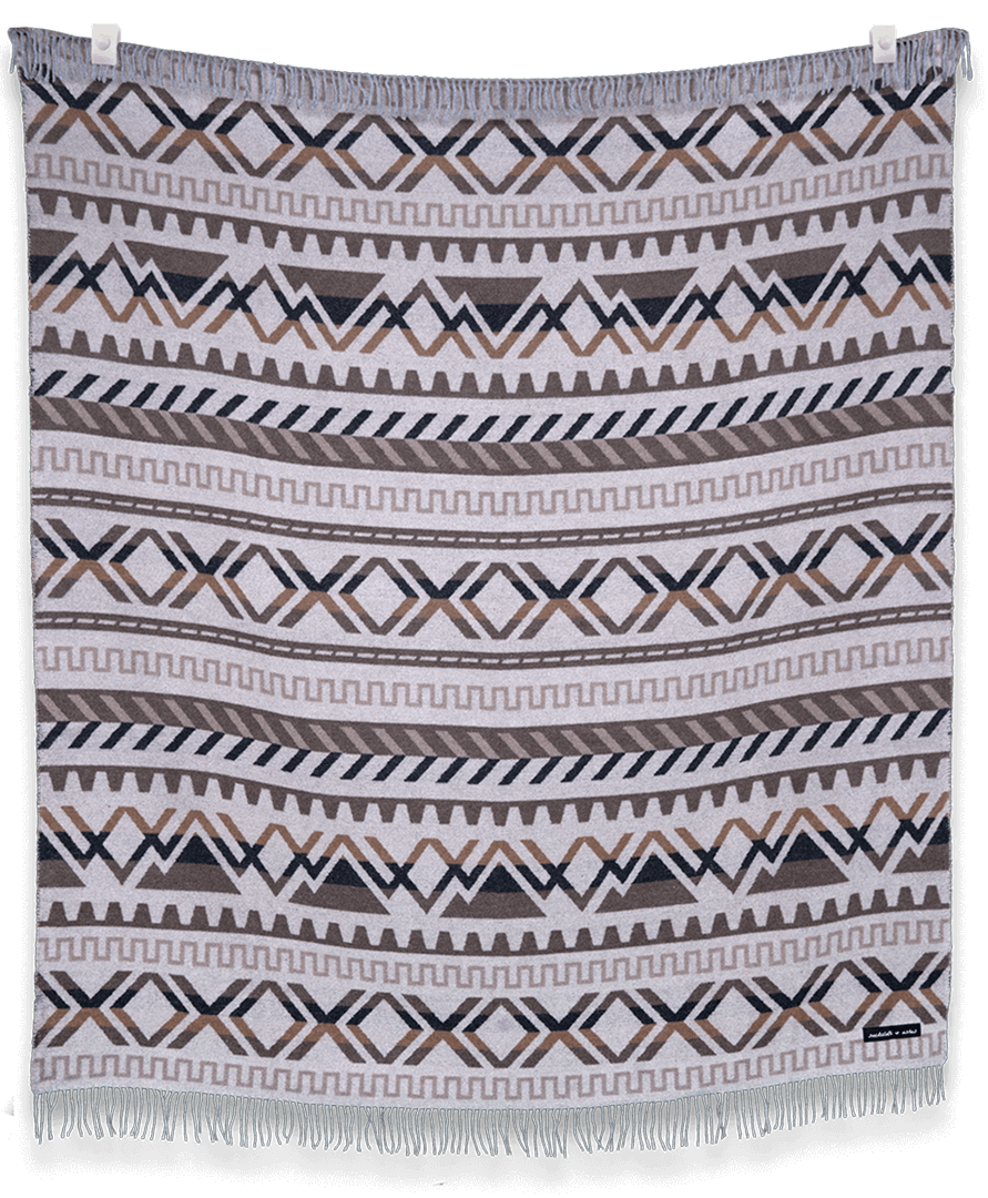 Patterned blanket with geometric design on a black background