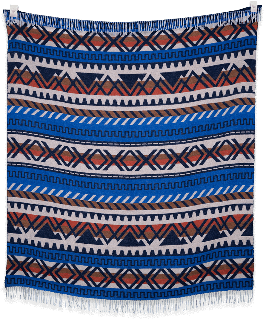 Woven blanket with blue, orange, and white geometric pattern on a black background