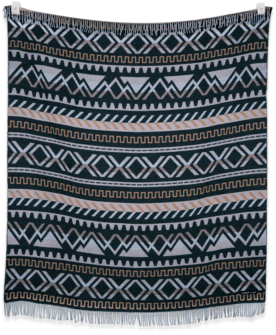 Patterned blanket with geometric design on a black background