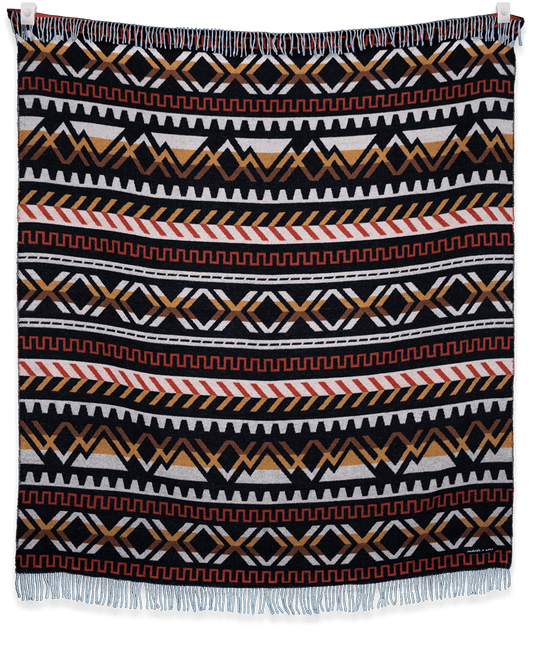 Woven blanket with geometric pattern on a black background