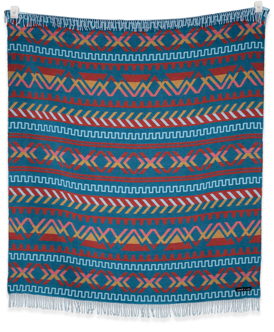Colorful patterned blanket with geometric design on a black background