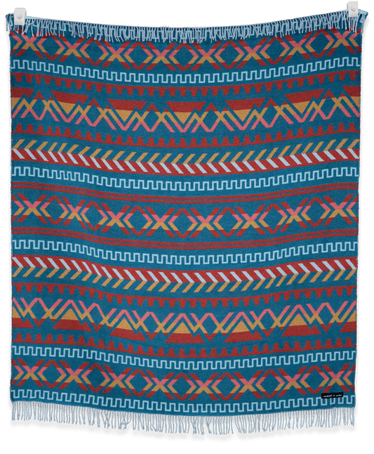 Colorful patterned blanket with geometric design on a black background