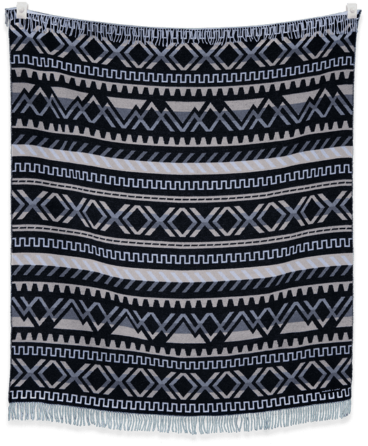 Patterned blanket with geometric design on a black background