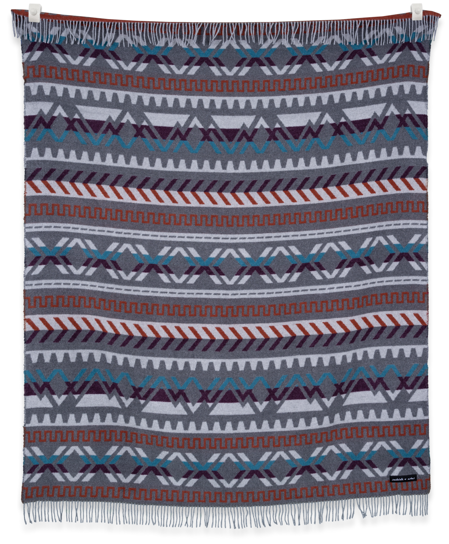 Woven blanket with geometric pattern on a white background